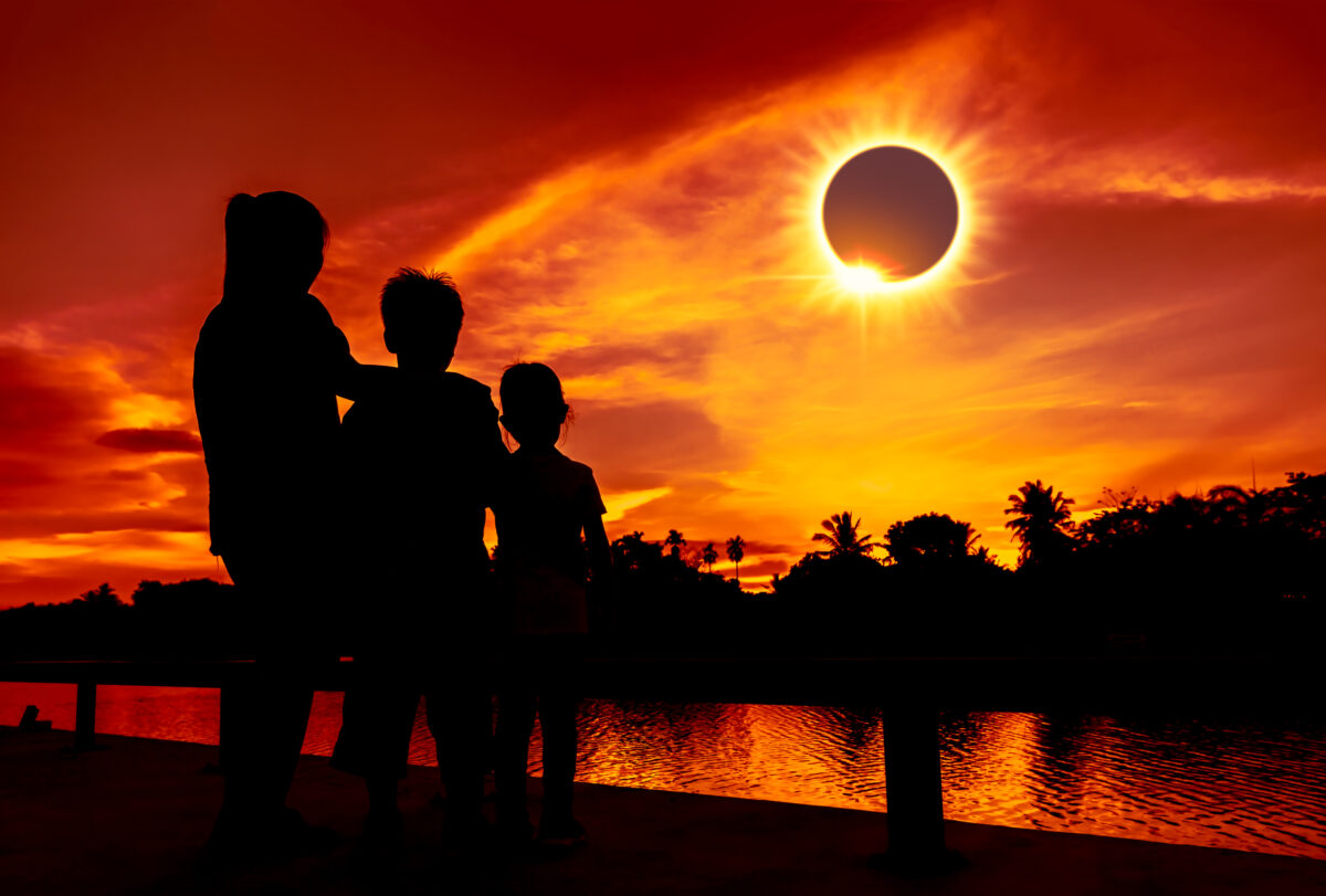 Natural phenomenon. Three looking at looking at total solar eclipse