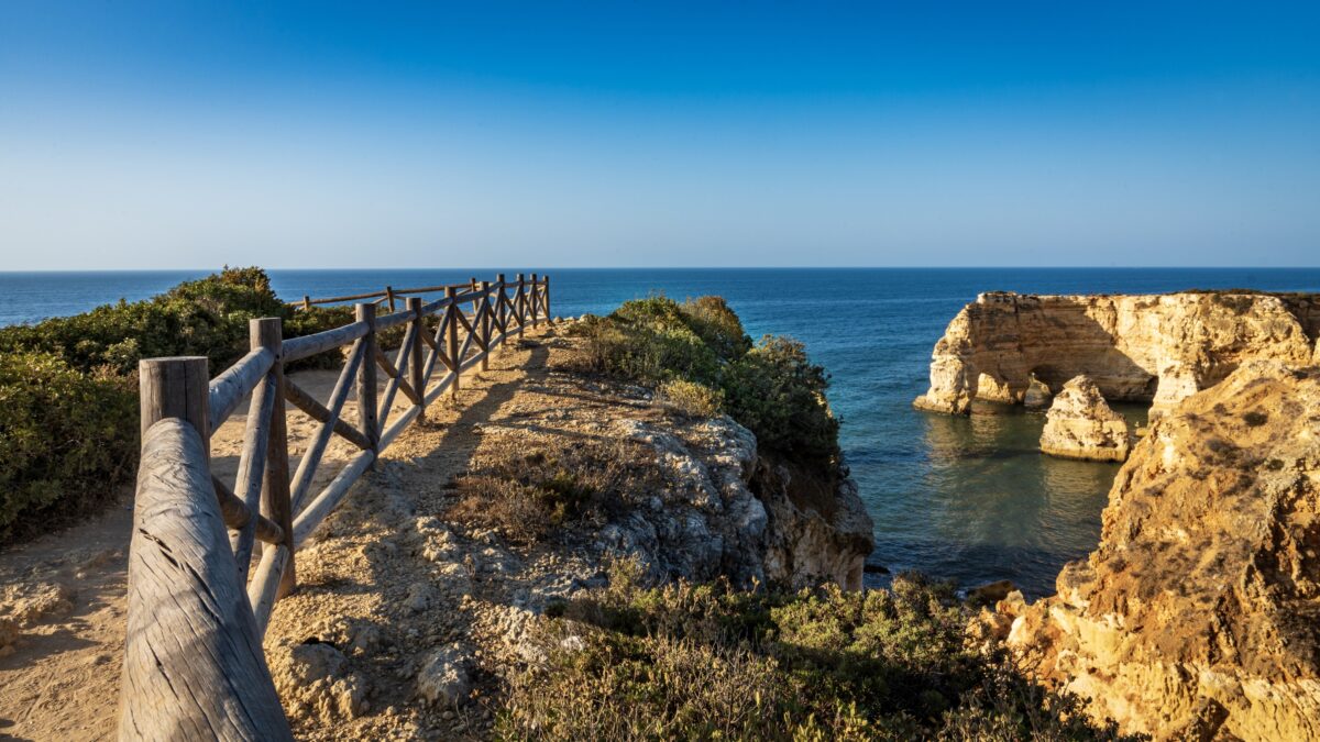 Coastal cliffs and beaches on a sunny blue sky morning along the Percurso dos Sete Vales trail, Algarve, Portugal