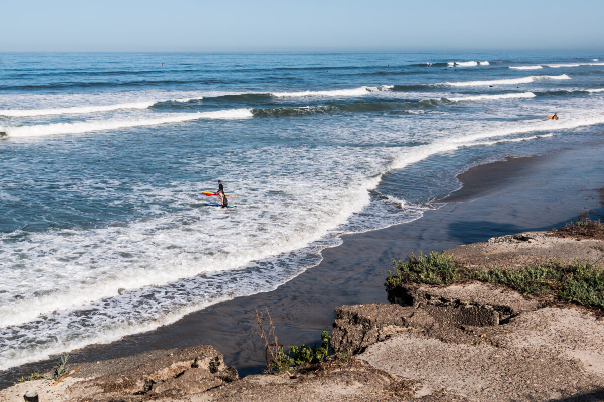 Male surfers at San Elijo State Beach in Cardiff, California, located in San Diego County