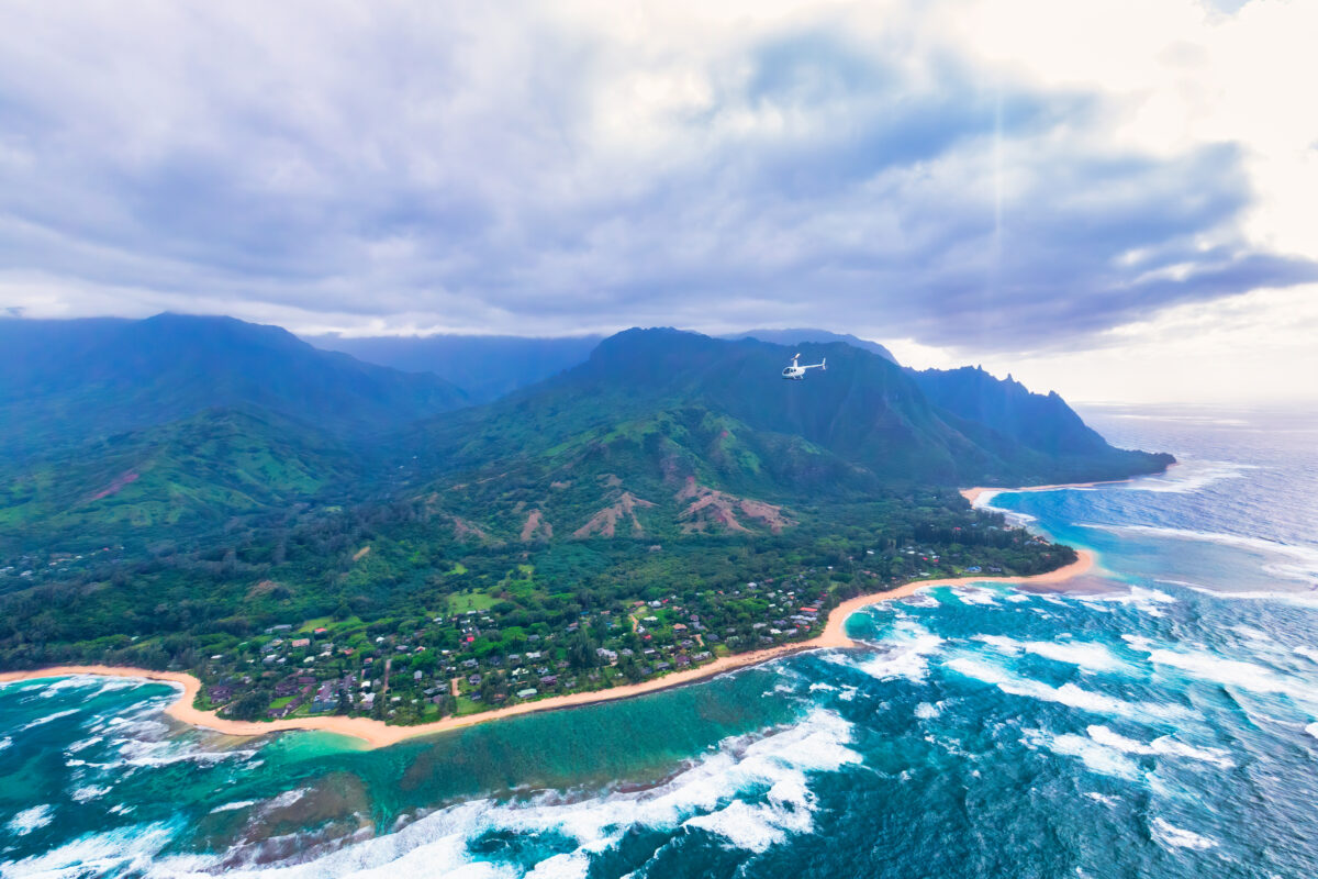 A Tour Helicopter Flies Over the Rear Side of Kauai`s Na Pali Coast in Hawaii