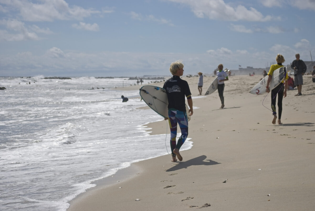 Surfers Belmar. A surfer ready to enter the surf at the Belmar Pro Surfing contest