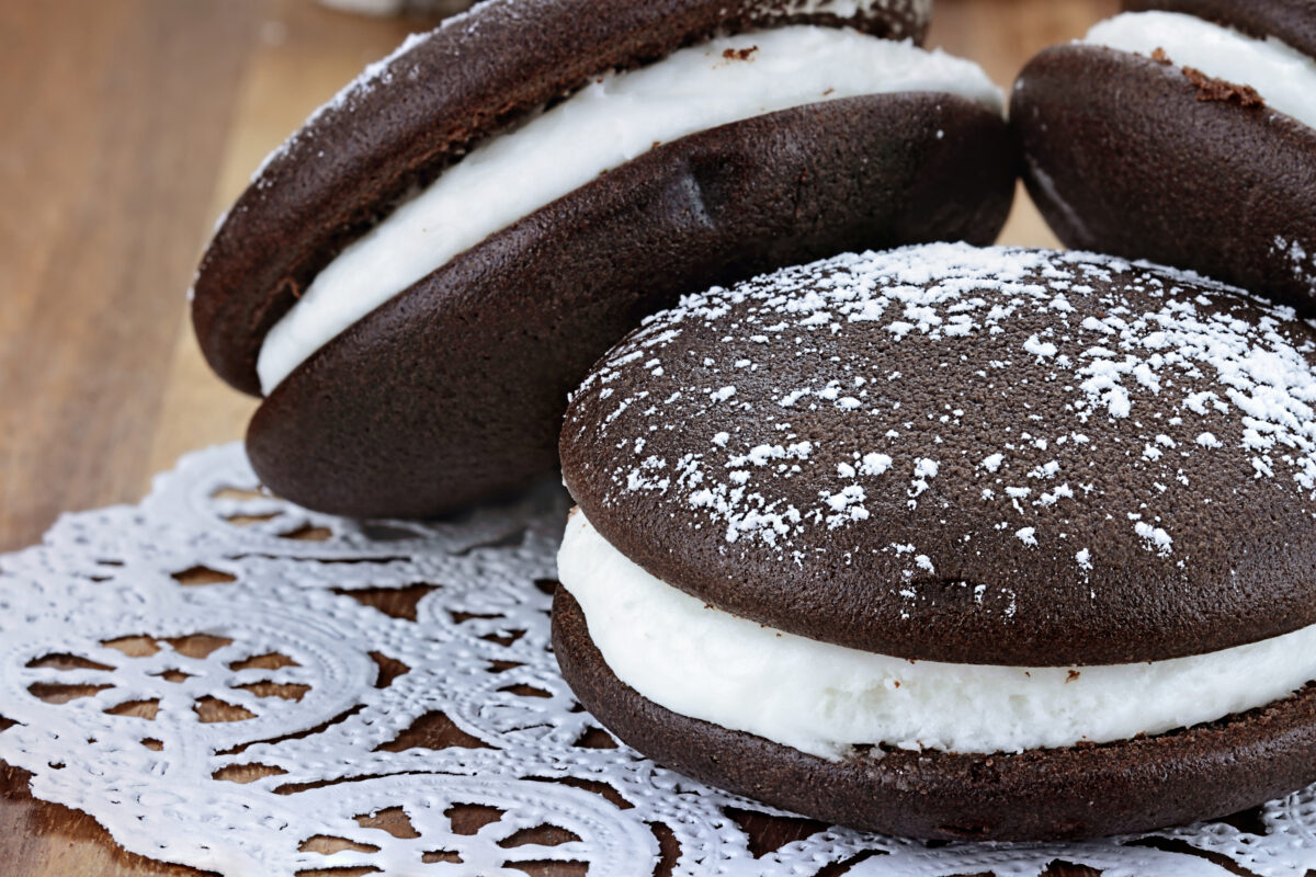 Macro image of three whoopie pies or moon pies with powdered sugar