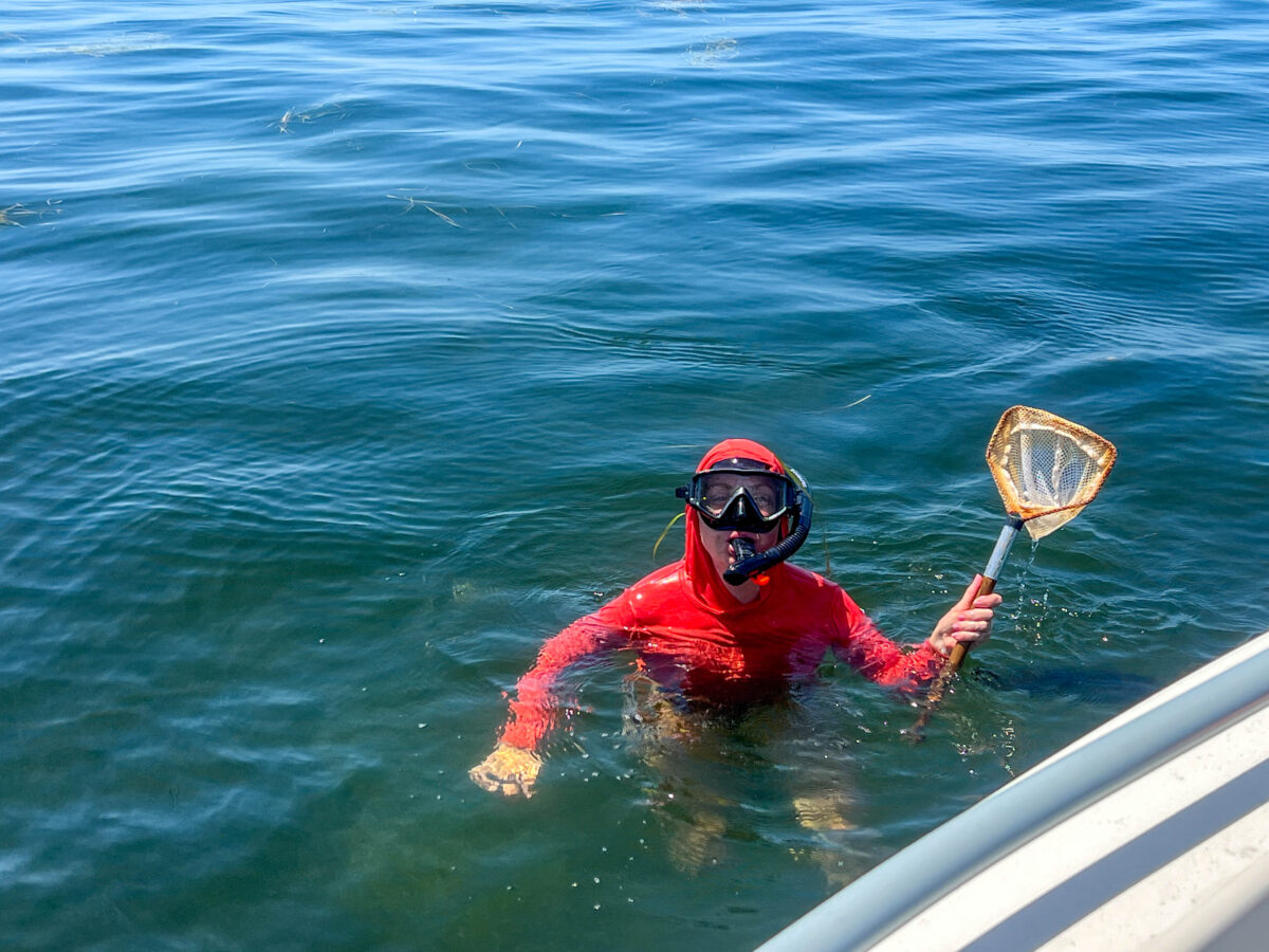 Girl in orange shirt and snorkel mask holding net_Homosassa_Florida_Brandy Jo Hastings_