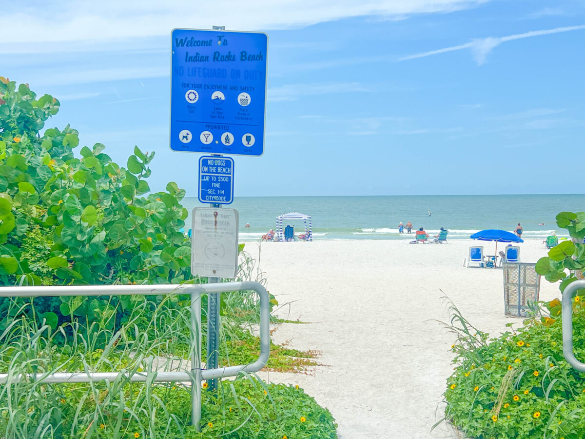 Indian Rocks Beach sign with greenery and beach and water behind_Indian Rocks Beach_Florida_Brandy Jo Hastings_