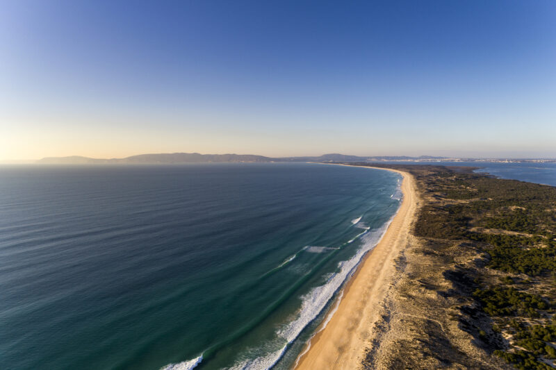 Aerial view of the Comporta Beach and the Troia Peninsula with the Arrabida Mountain on the background, in Portugal