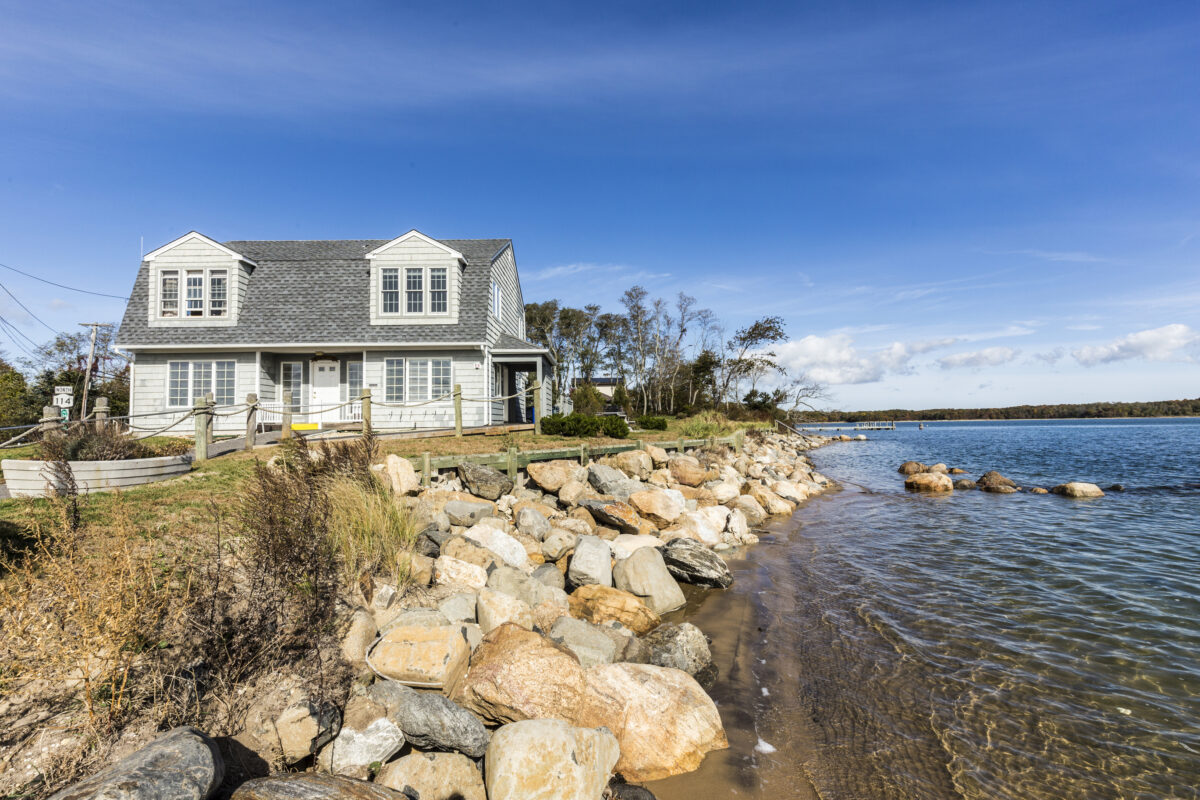 View to traditional historic house at shelter Island with ticket office for south ferry, USA