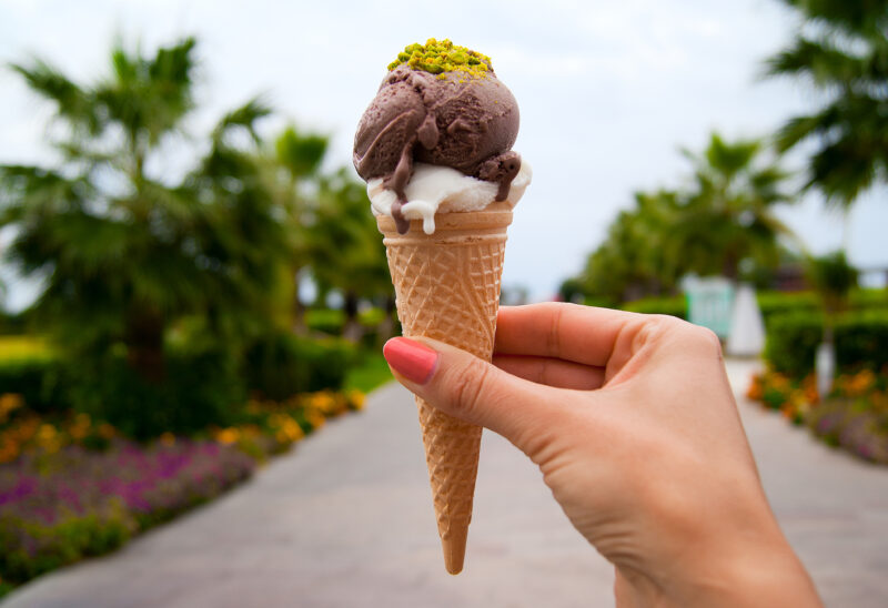 Close-up of someone holding an ice cream cone.