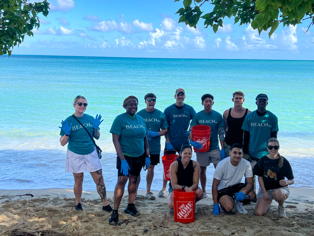 Group of friends on beach in beach t shirts with orange bucket_St Croix USVI_Brandy Jo Hastings
