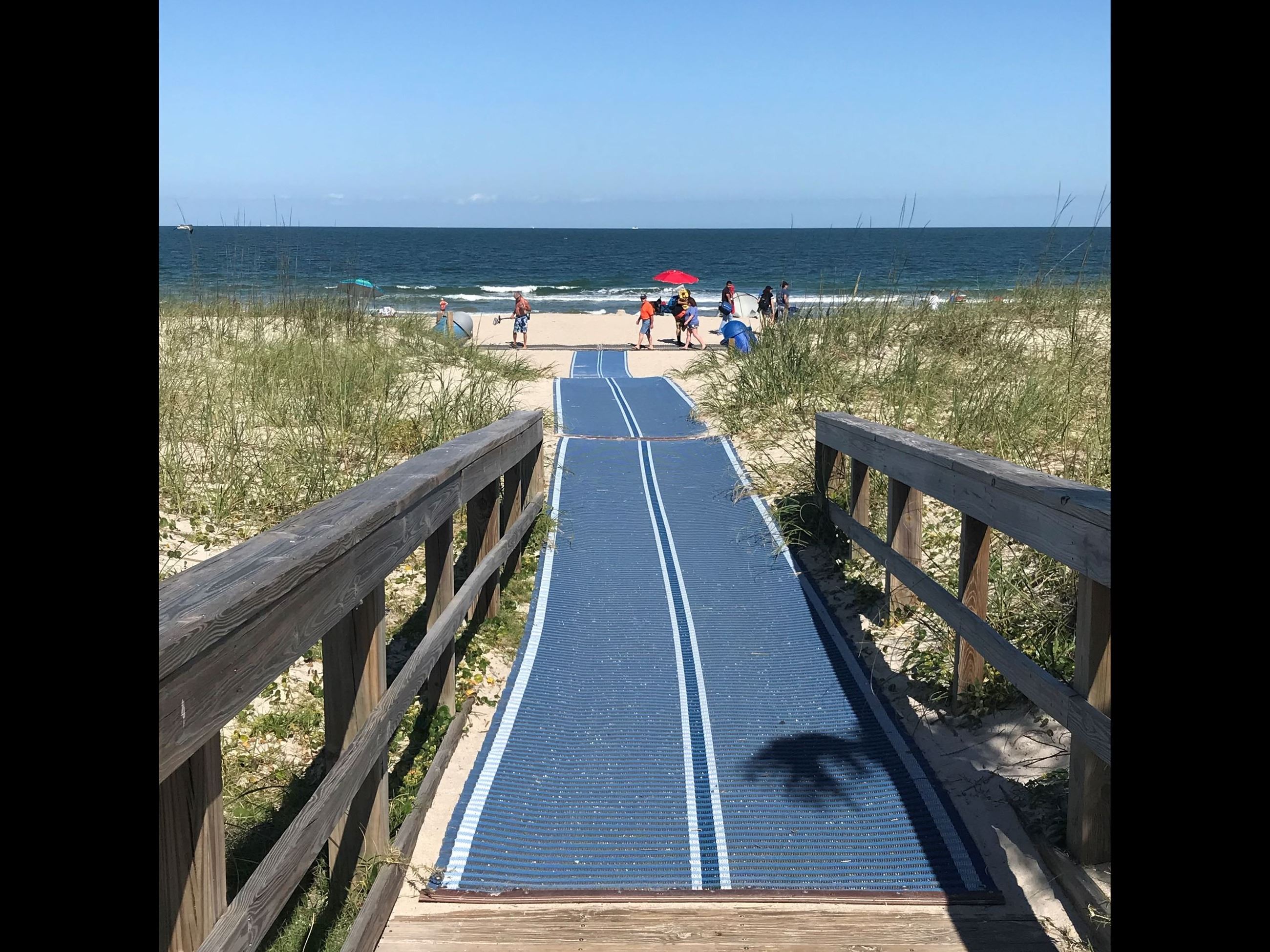 A long beach access mat extends from a boardwalk across the sand to the high-tide line at Fernandina Beach - Main Beach.