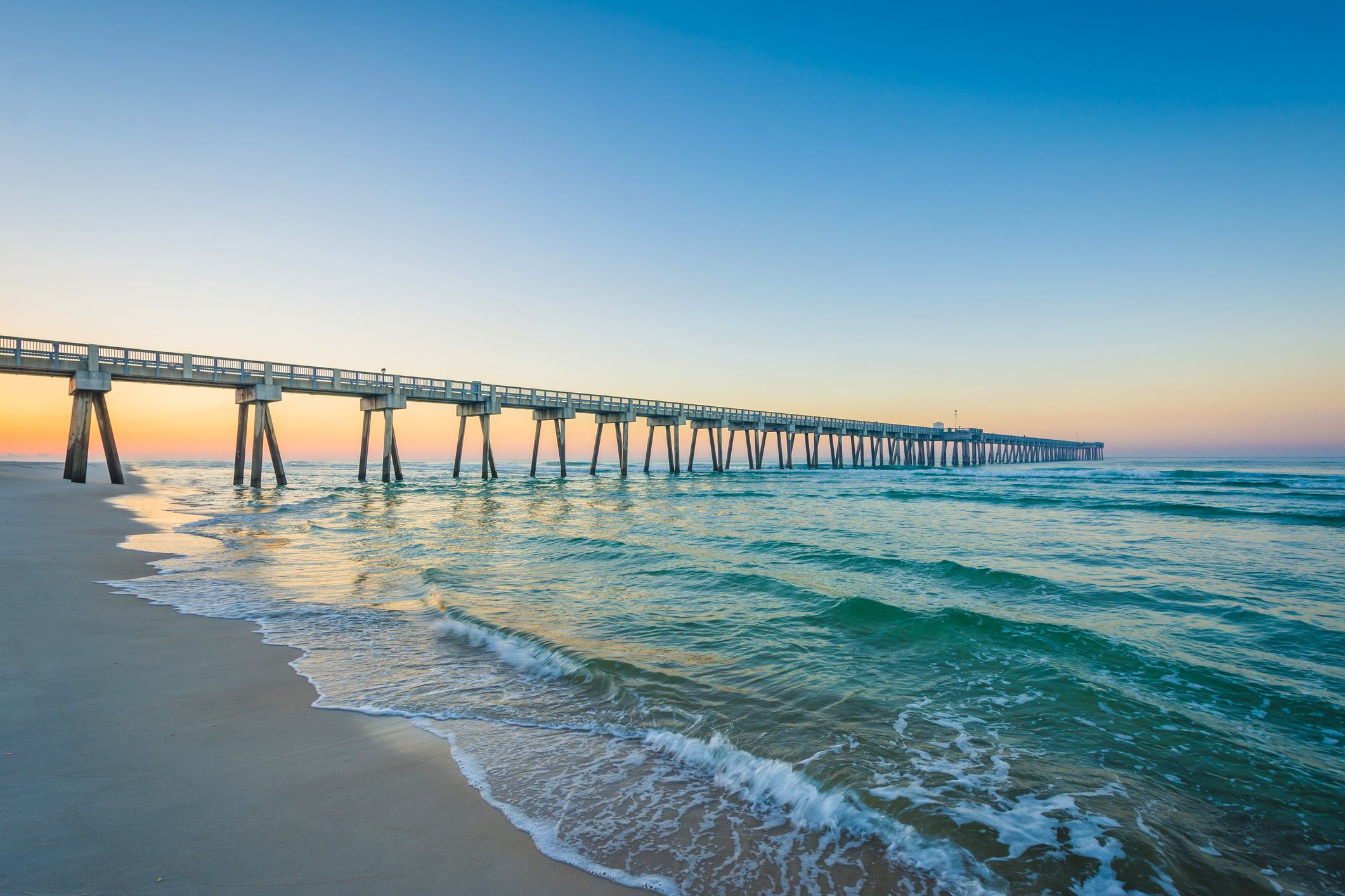 The M. B. Miller County Pier and Gulf of Mexico at sunrise, in Panama City Beach, Florida.