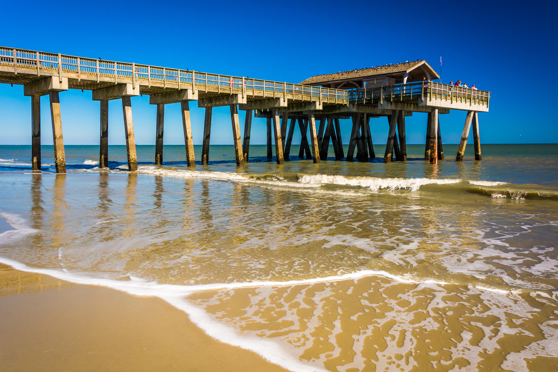 View from the shore of the fishing pier and Atlantic Ocean at Tybee Island, Georgia.