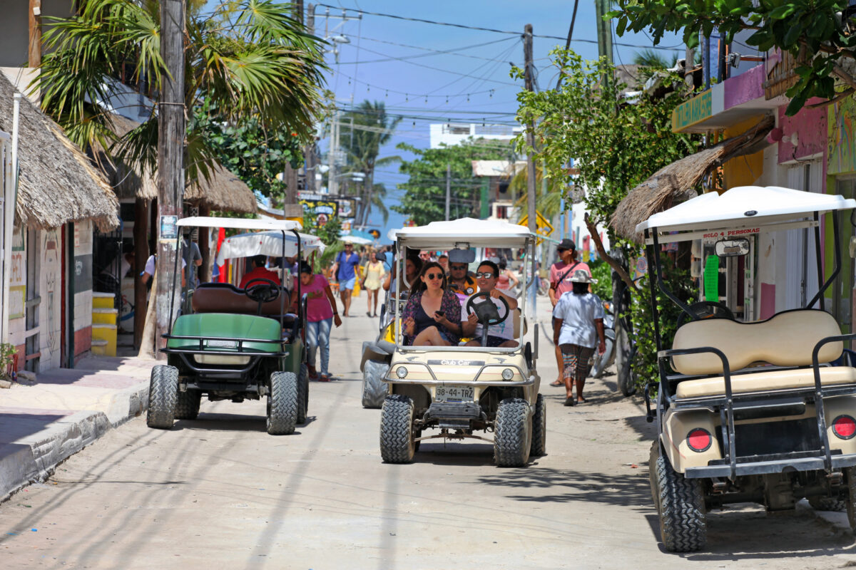Discover the Caribbean island with a fun golf car in Mexico on the white sand paths on the sea shore, for a perfect holiday